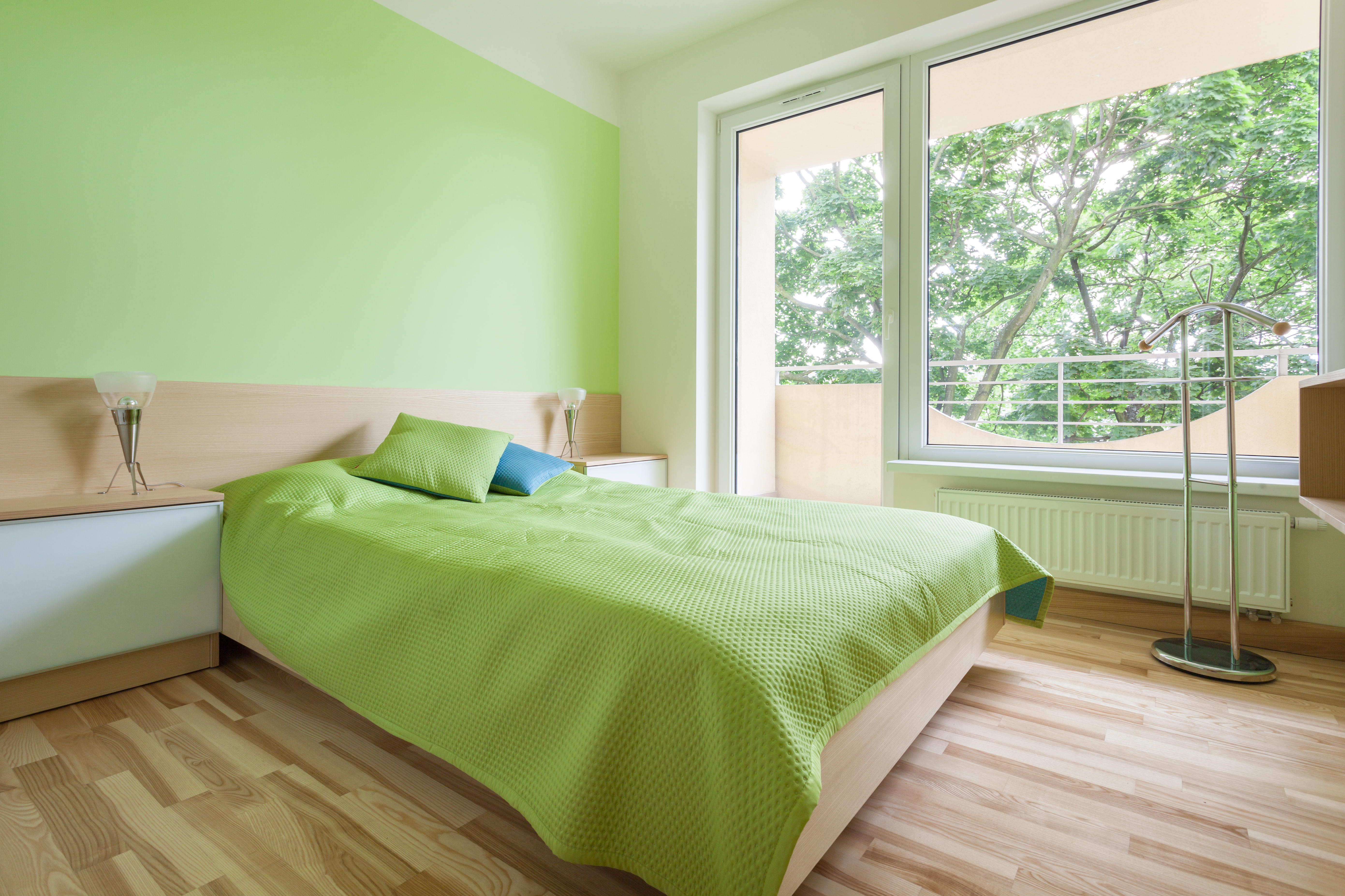 Horizontal interior of bedroom with green elements